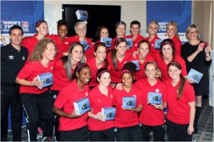 Members of the Canadian Women's National Soccer team show off their new Canon PowerShot cameras, presented to them by Colleen Ryan Senior Director of Corporate Communications, Canon Canada, at right. (Photo: Canon Canada Inc.)
